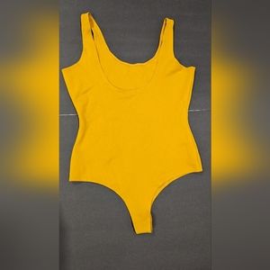 Shinestar yellow bodysuit new. Large